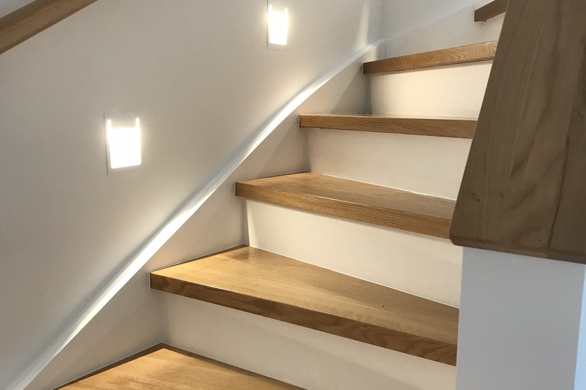 Einzelne Treppenstufen mit weißer Front und Holzfläche