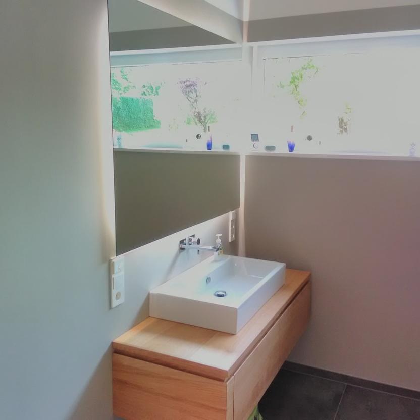 Waschebeckenunterschrank aus Holz unter Spiegel mit eckigem Waschebecken