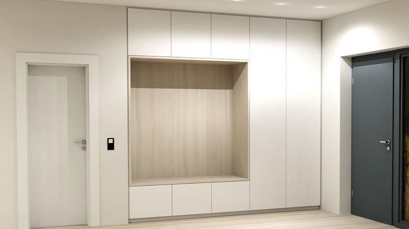 Ein geräumiger, heller Raum mit einem großen, maßgefertigten Einbauschrank neben einer weißen Tür und einer dunklen Eingangstür.