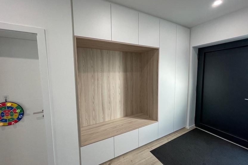 Individueller Einbauschrank nach Maß mit weißen Fronten und Holzaussparung