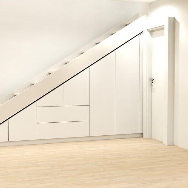 Maßgefertigter Einbauschrank in Weiß, integriert unter einer Treppe in einem Raum mit hellem Holzboden und neutraler Wandfarbe.