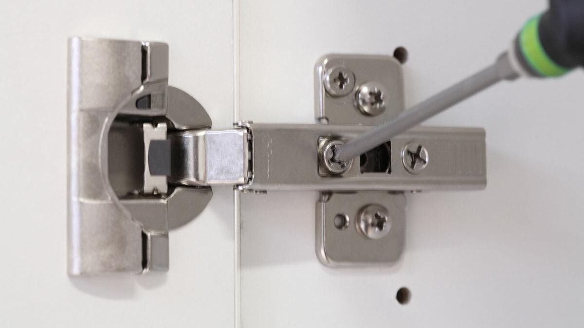 Detailaufnahme eines mit Schraubendreher nachjustierbaren Türscharniers